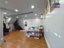 Spacious Living Area with Wooden Flooring and Staircase