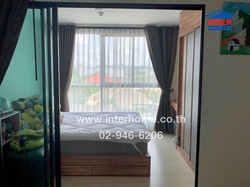 Cozy bedroom with large window and glass sliding door