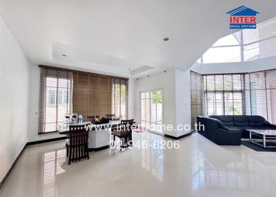 Spacious living room with dining area and large windows