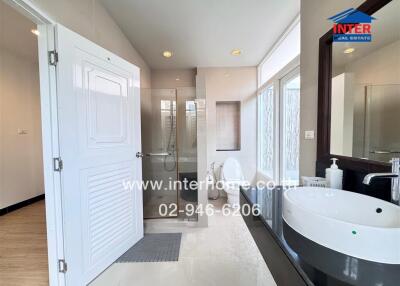 Modern bathroom with a shower, sink, and toilet