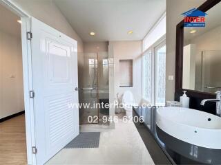 Modern bathroom with a shower, sink, and toilet