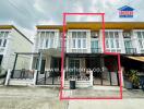 Front view of townhouse with three floors and a gated front area