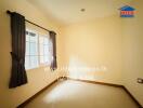 Empty bedroom with a window and curtains