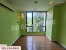 Bright bedroom with green walls and large window