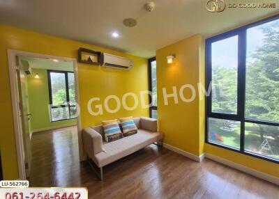 Bright living room with yellow walls and large windows