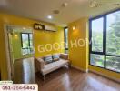 Bright living room with yellow walls and large windows