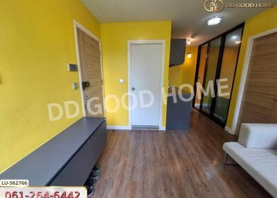 Bright living area with yellow walls and wood flooring