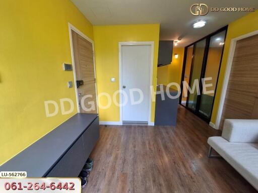 Bright living area with yellow walls and wood flooring