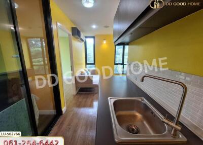 Modern kitchen with yellow walls and wooden flooring