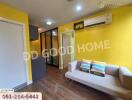 Modern living room with yellow walls and a sofa