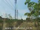 vacant land with cell towers and greenery