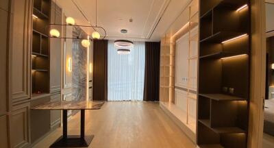 Modern dining area with contemporary lighting and shelves