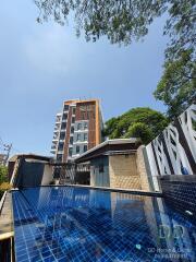 Front view of a modern building with a pool