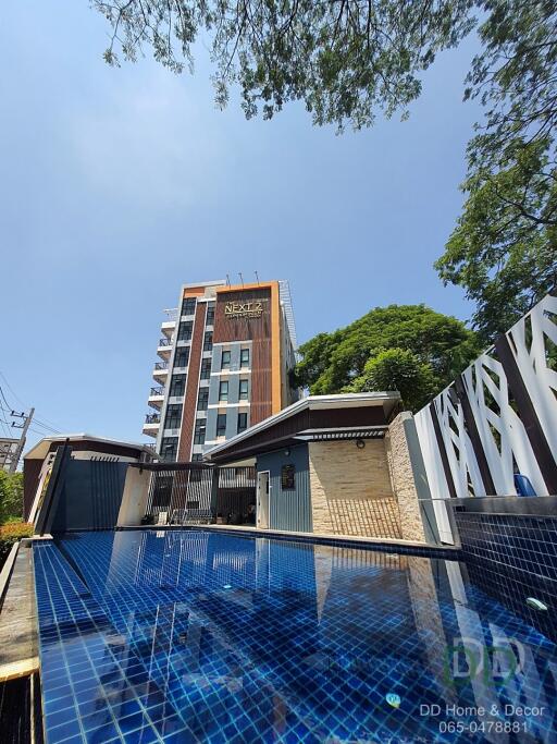 Front view of a modern building with a pool