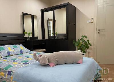 Bedroom with bed, mirror wardrobe, and plush elephant