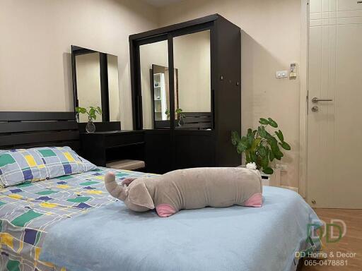 Bedroom with bed, mirror wardrobe, and plush elephant