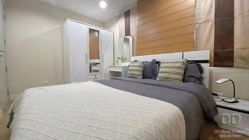 Cozy and modern bedroom with wooden accent wall and white furniture