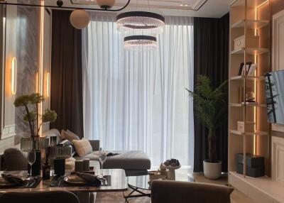 Modern living room with large windows, stylish furniture, and elegant lighting
