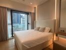 A modern bedroom with a large bed, floor-to-ceiling window with curtains, and a built-in mirror wardrobe.