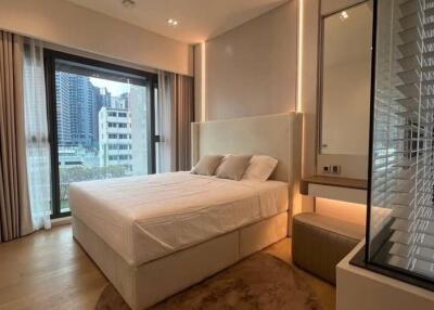 Modern bedroom with large window and view of the cityscape