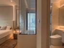 Modern bedroom with ensuite bathroom featuring city view