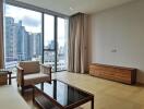 Modern furnished living room with large windows and city view