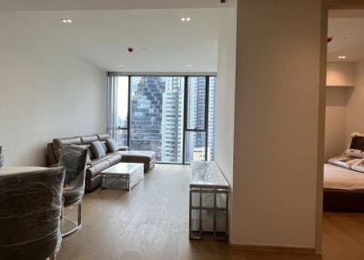 Modern living room with city view and adjoining bedroom