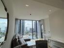 Spacious living room with floor-to-ceiling windows and city view