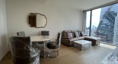 Modern living room with a dining area and large window