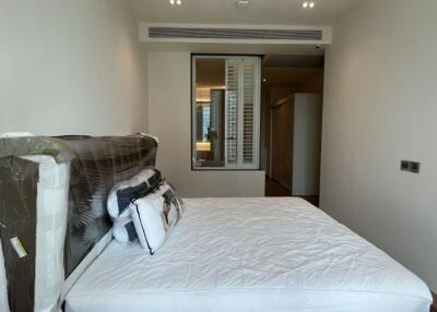Modern, unfurnished bedroom with a large window and bed frame