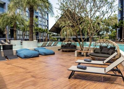 Outdoor pool area with lounge chairs and seating