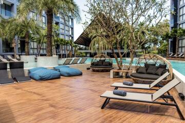 Outdoor pool area with lounge chairs and seating