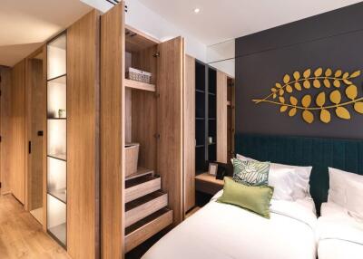 Modern bedroom with built-in wooden wardrobes and green decor