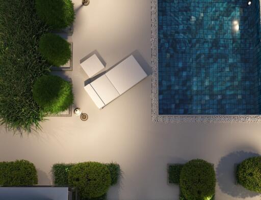 Aerial view of a poolside with a lounge chair and greenery