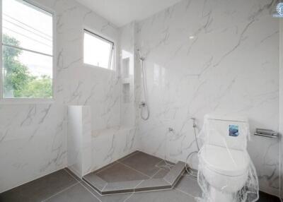 Modern bathroom with marble tiles and large windows