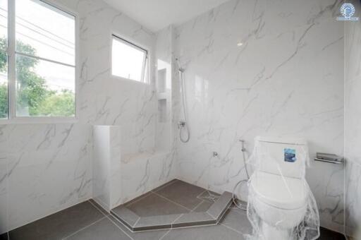 Modern bathroom with marble tiles and large windows