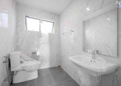 Modern bathroom with white marble walls and fixtures
