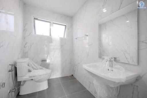 Modern bathroom with white marble walls and fixtures