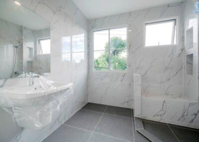 Modern bathroom with marble walls and fixtures