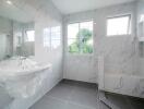 Modern bathroom with marble walls and fixtures