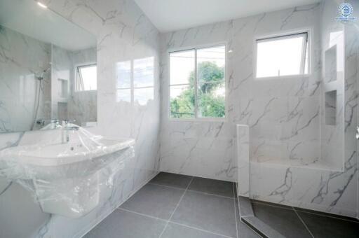 Modern bathroom with marble walls and fixtures