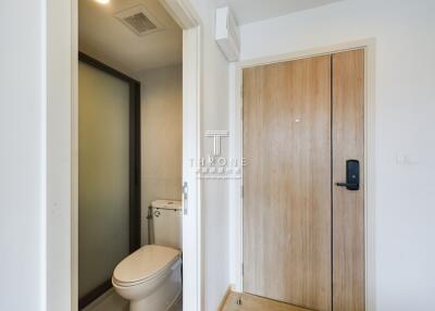 Bathroom with toilet and wooden door
