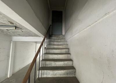 Staircase leading to an upper floor with bare walls