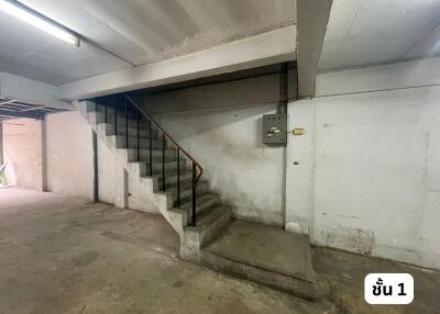 Staircase inside a building with concrete walls and floor