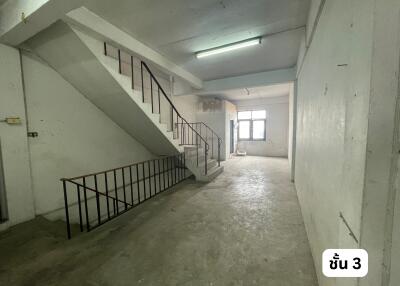 Concrete stairwell area with fluorescent lighting