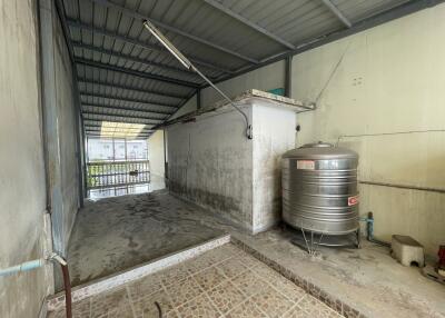 Covered utility area with water storage tank