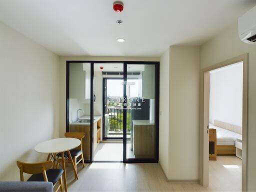 Modern open-plan living area with kitchen and bedroom