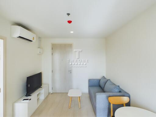 Living room with couch, coffee tables, TV, and air conditioner