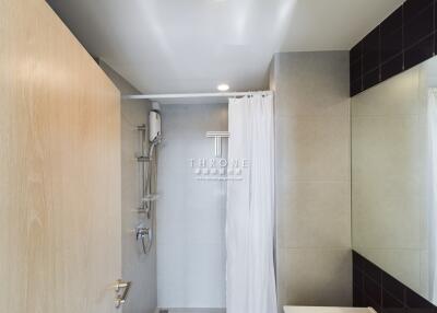 Modern bathroom with shower and large mirror
