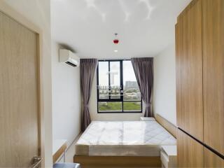 Modern bedroom with large window and natural lighting